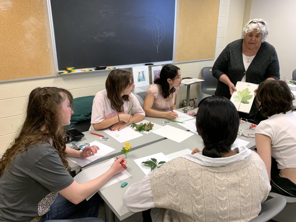 Claire Miller teaching botanical illustration in Maggie Cao's ARTH 64 class